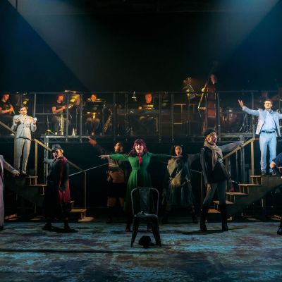 Urinetown production image showing the cast in a large group on stage